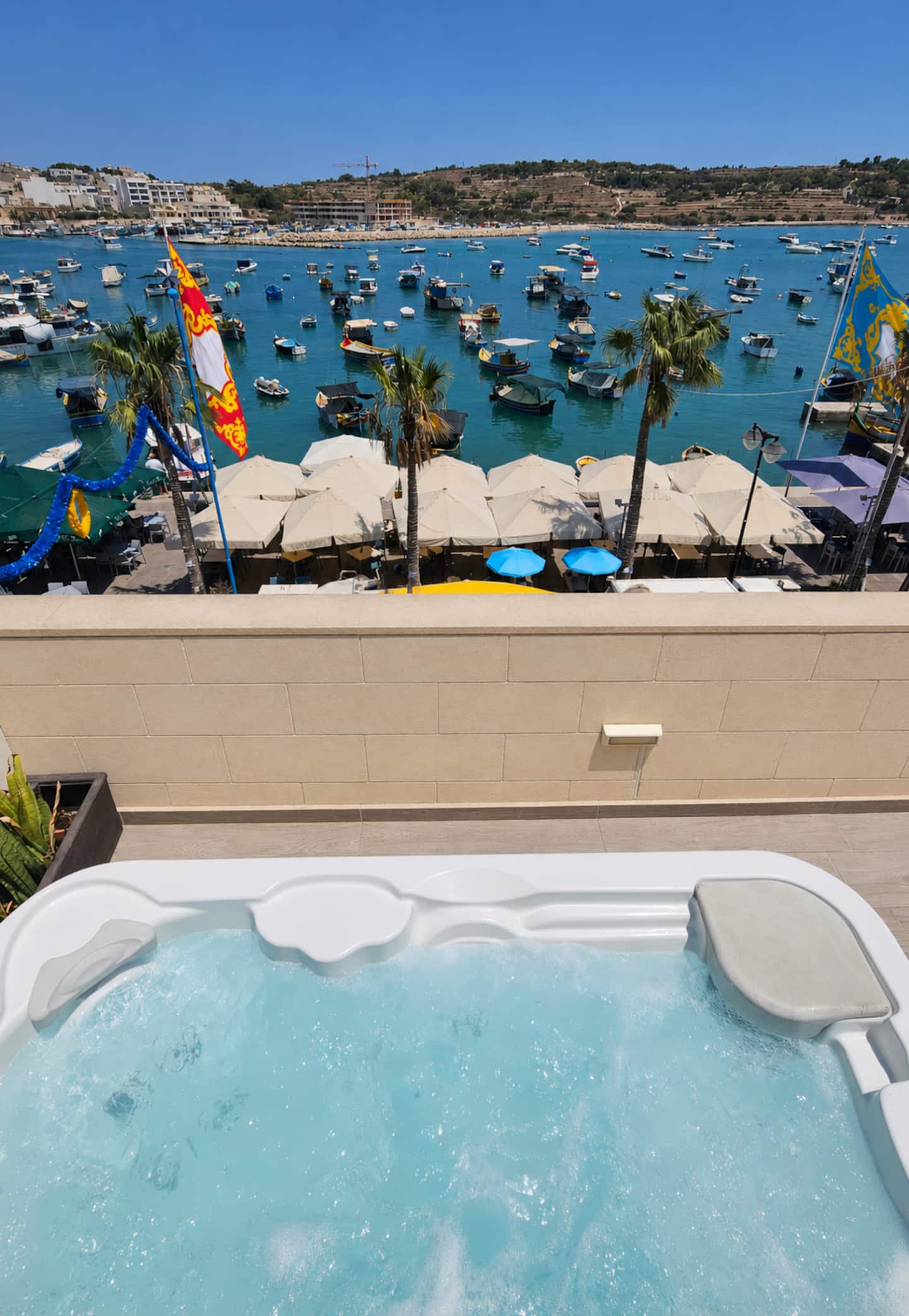 Private hot tub on the Mr Fitz Penthouse terrace overlooking Marsaxlokk Bay