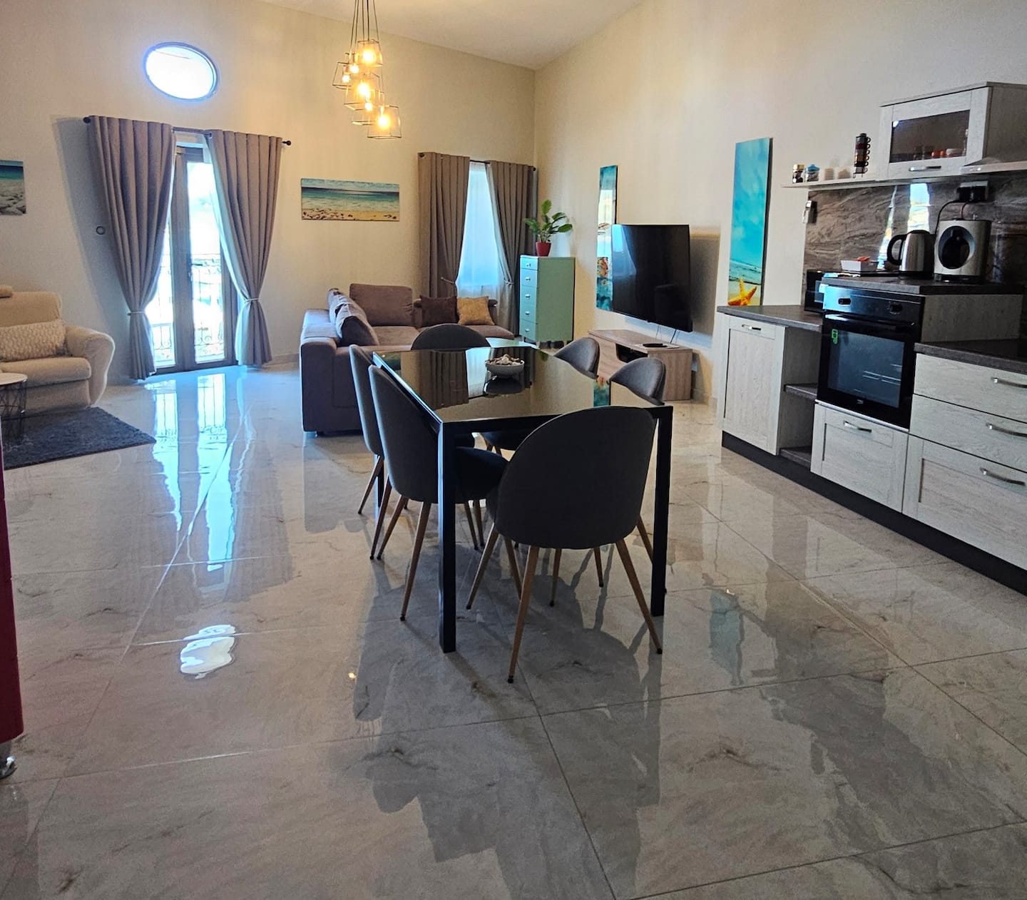Open-plan living, dining and kitchen area of the harbour view apartment